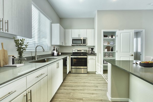 Modern kitchen with stainless steel appliances at Abode at Litchfield Park Apartments