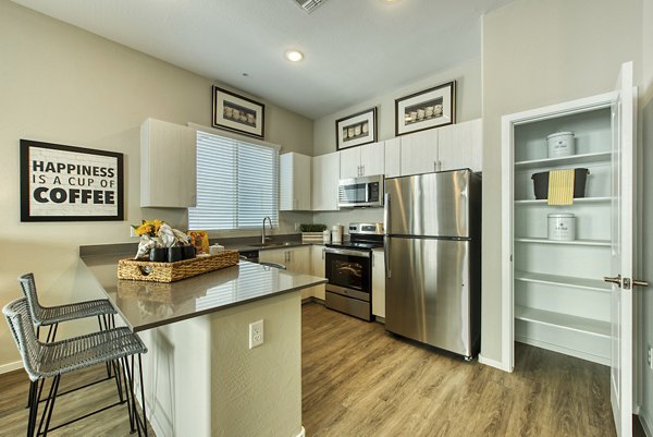 Contemporary kitchen with stainless steel appliances at Abode at Litchfield Park Apartments, a Greystar luxury apartment community