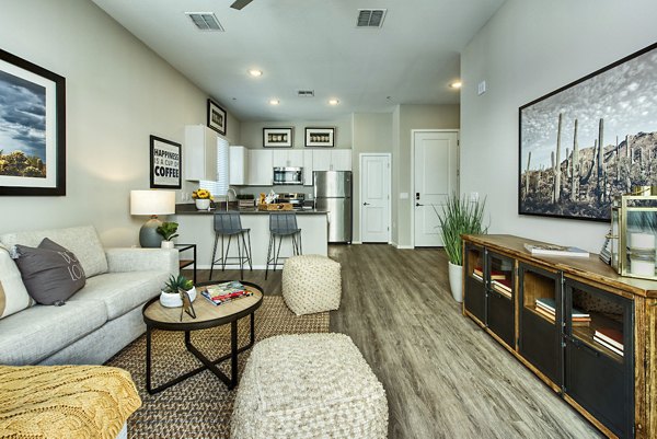 Living room with modern furnishings and natural light at Abode at Litchfield Park Apartments