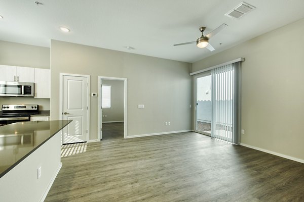 Modern living room with elegant furnishings at Abode at Litchfield Park Apartments, featuring sleek design and cozy ambiance