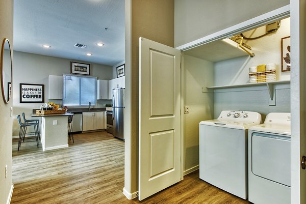 Laundry room with modern appliances at Abode at Litchfield Park Apartments