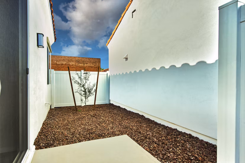 Spacious patio for outdoor relaxation at Abode at Litchfield Park Apartments, featuring modern furnishings and lush greenery
