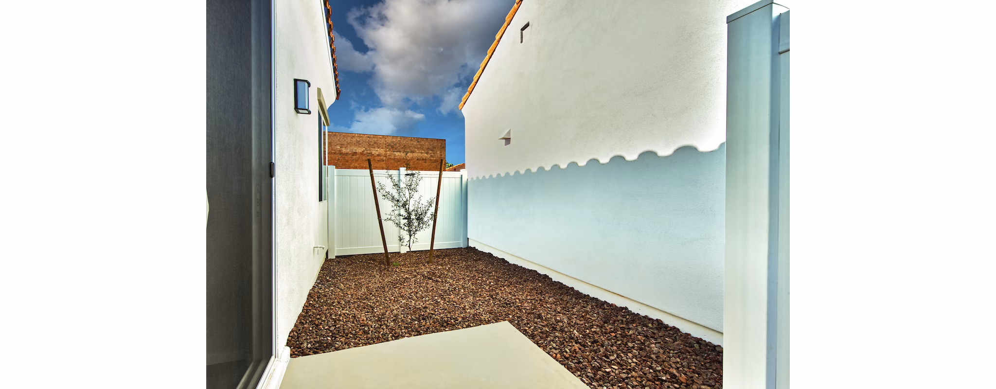 Spacious patio for outdoor relaxation at Abode at Litchfield Park Apartments, featuring modern furnishings and lush greenery