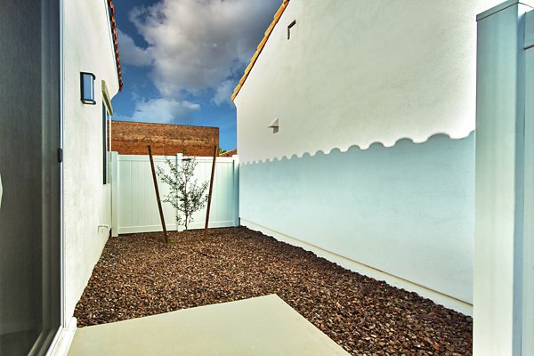 Spacious patio for outdoor relaxation at Abode at Litchfield Park Apartments, featuring modern furnishings and lush greenery