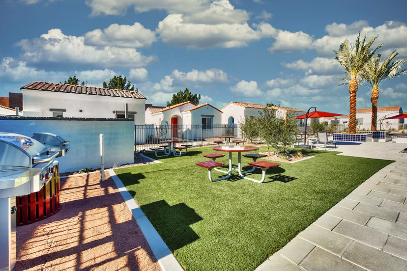 Grill area with patio seating at Abode at Litchfield Park Apartments offers a perfect outdoor dining experience