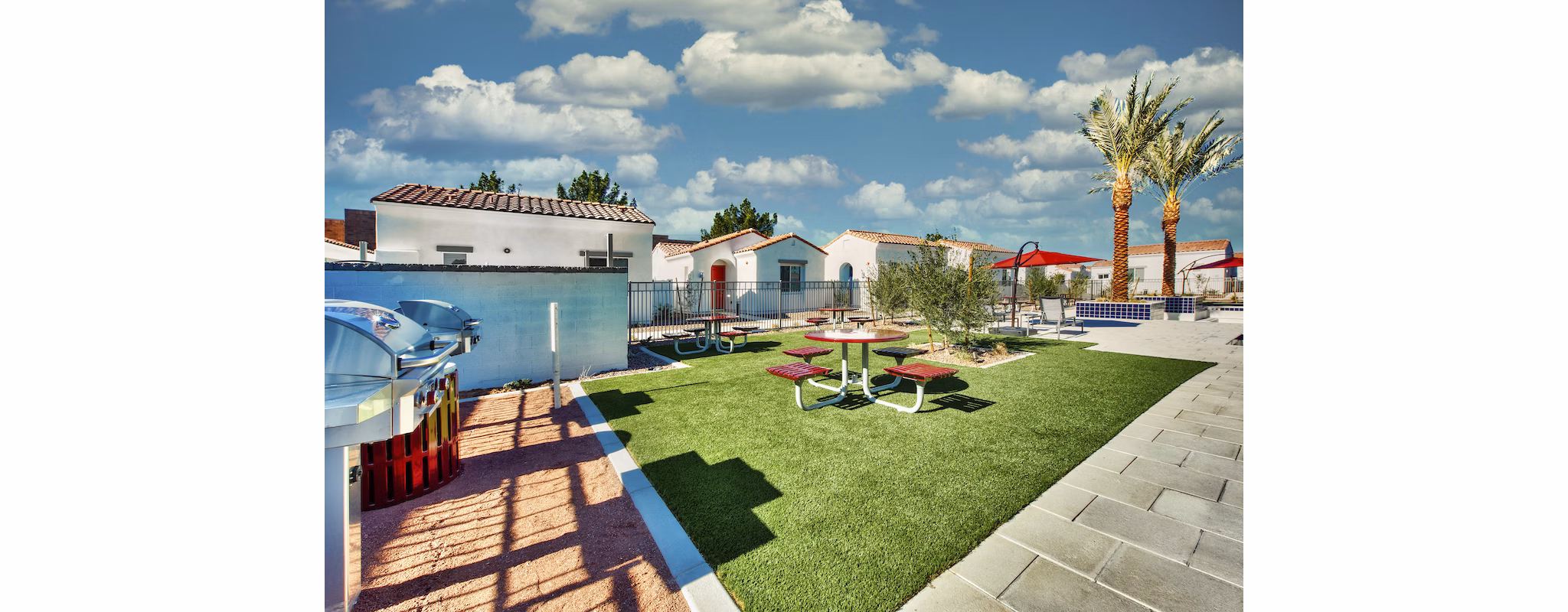 Grill area with patio seating at Abode at Litchfield Park Apartments offers a perfect outdoor dining experience