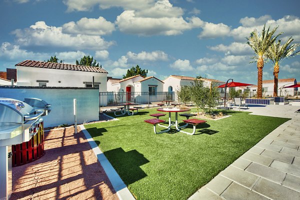 Grill area with patio seating at Abode at Litchfield Park Apartments offers a perfect outdoor dining experience