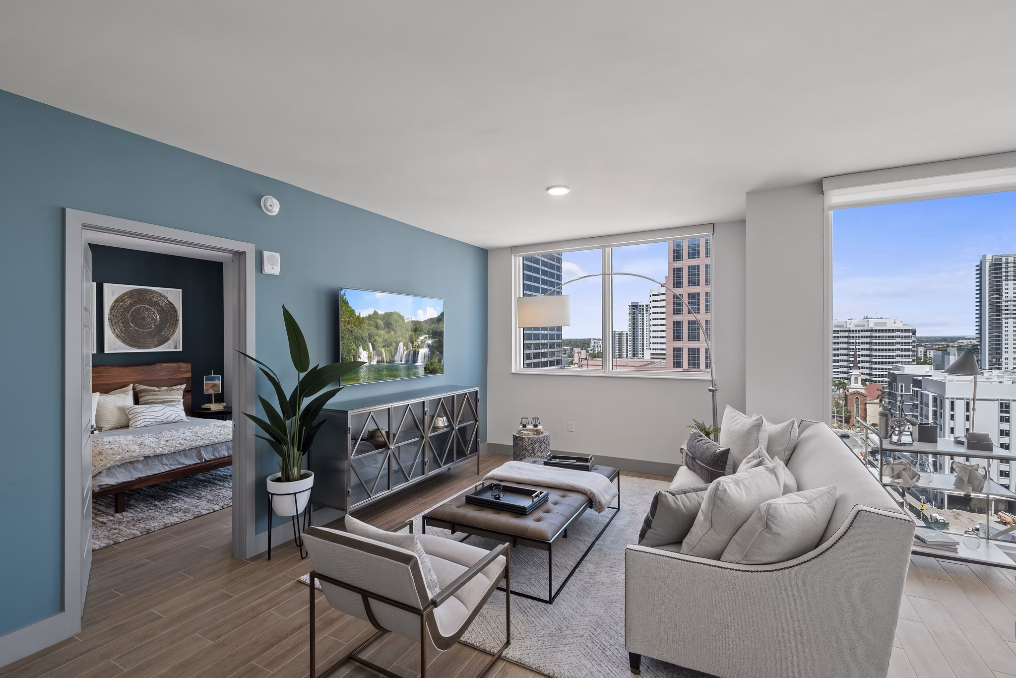 Spacious living room with modern decor and large windows in NOVO Las Olas Apartments