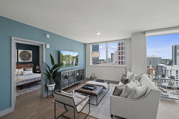 Spacious living room with modern decor and large windows in NOVO Las Olas Apartments