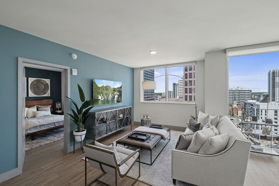 Spacious living room with modern decor and large windows in NOVO Las Olas Apartments