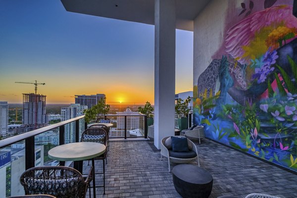 Spacious patio with seating and garden views at NOVO Las Olas Apartments