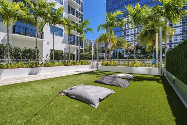 Terraced green courtyard with seating at NOVO Las Olas Apartments, a luxury community offering serene outdoor spaces