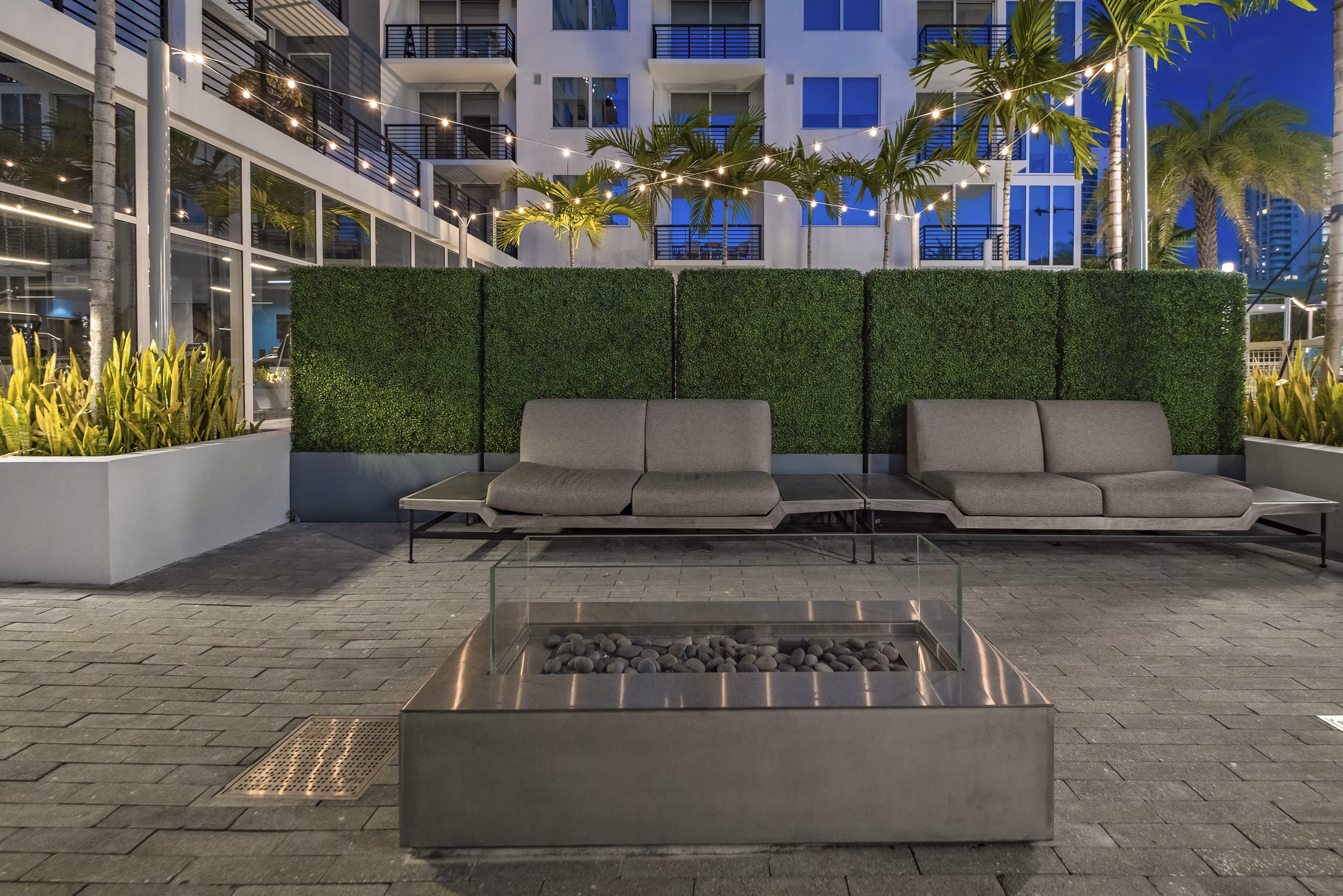 Fire pit lounge area at NOVO Las Olas Apartments with seating and modern design for leisure and relaxation