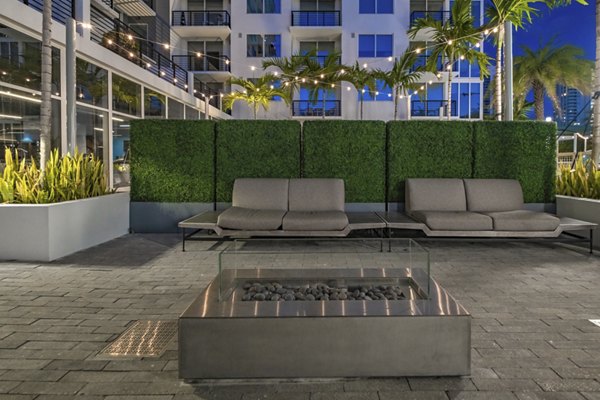 Fire pit lounge area at NOVO Las Olas Apartments with seating and modern design for leisure and relaxation