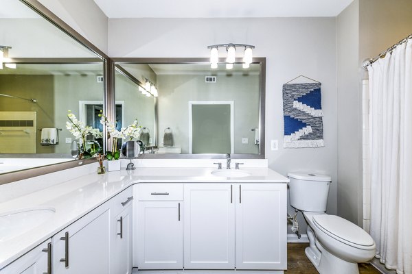 Bathroom with sleek fixtures and marble countertops at Avana Cheshire Bridge Apartments