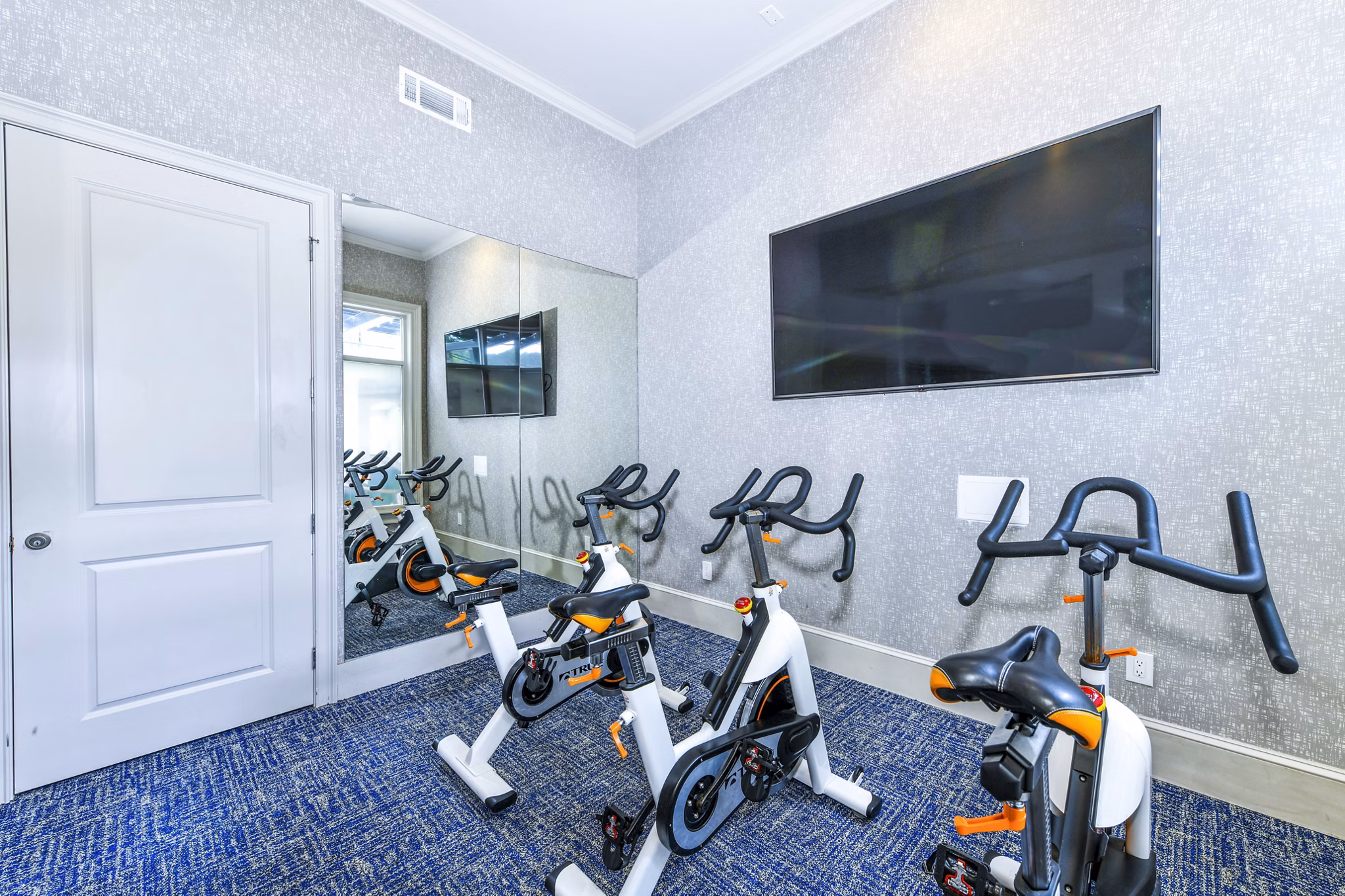Modern spin studio with state-of-the-art equipment at Avana Cheshire Bridge Apartments, ideal for fitness enthusiasts seeking luxury living amenities