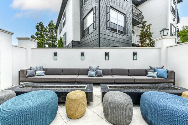 Spacious outdoor patio at Avana Cheshire Bridge Apartments featuring comfortable seating and greenery