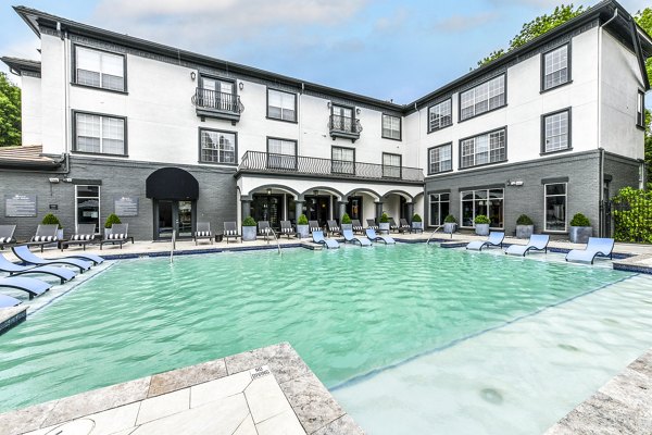 Resort-style pool with lush surroundings at Avana Cheshire Bridge Apartments for luxury living