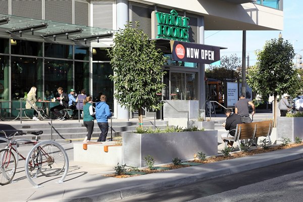 Modern streetscape view near Whole Foods in a residential area, highlighting vibrant city living at Greystar luxury apartments