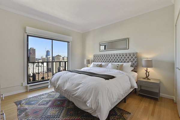 Spacious bedroom with city skyline views at Nob Hill Tower Apartments, luxury living in San Francisco