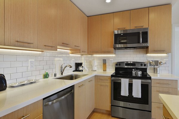 Modern kitchen with sleek countertops and stainless steel appliances at Nob Hill Tower Apartments