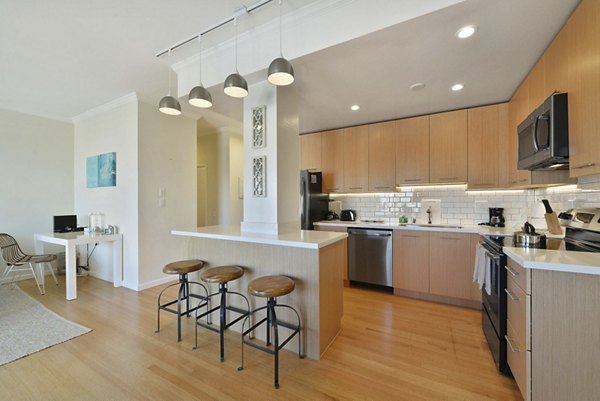 Modern kitchen with stainless steel appliances at Nob Hill Tower Apartments