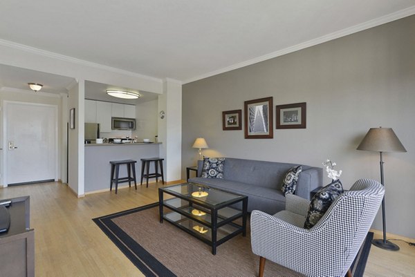 Spacious living room with modern furnishings in Nob Hill Tower Apartments, offering luxury living in a prime location