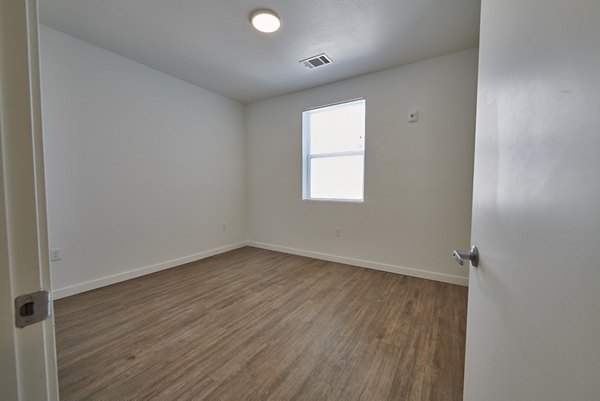 Bedroom featuring plush bedding and modern decor at Alpine Vista Apartments