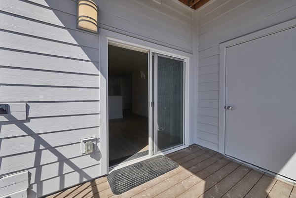 Alpine Vista Apartments: Scenic patio with mountain views, perfect for relaxation and outdoor dining