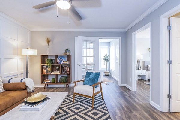 Modern living room with cozy sectional and large windows in Avana Avebury Apartments, featuring luxury design and ample natural light