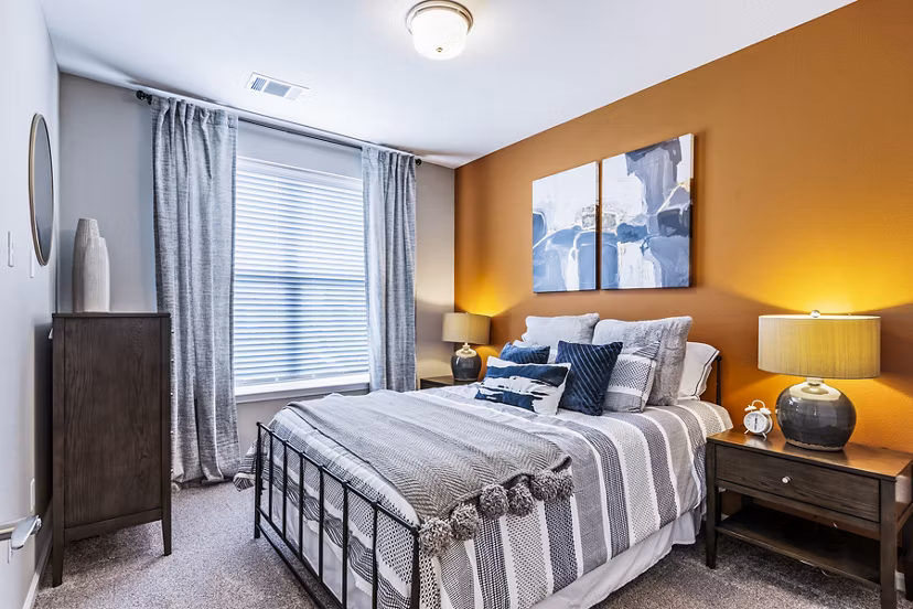 Elegant bedroom with modern furnishings at The Landing at Tiffany Springs Apartments