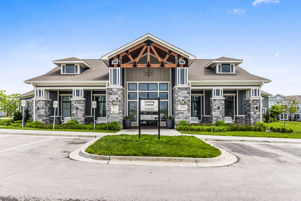 Clubhouse lobby with modern dÃ©cor and cozy seating at The Landing at Tiffany Springs Apartments