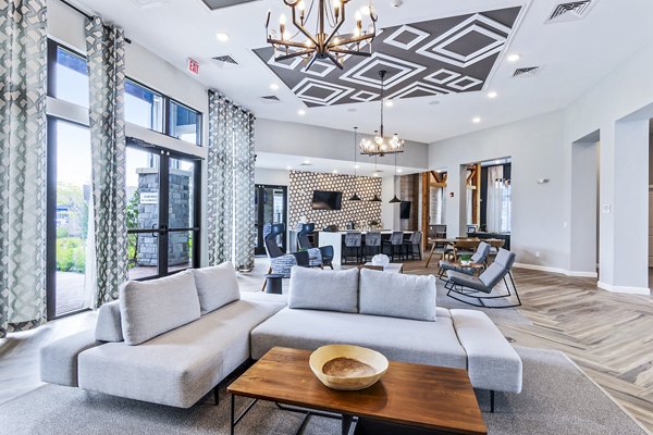 Clubhouse lobby with modern seating and decor at The Landing at Tiffany Springs Apartments, offering luxury living spaces
