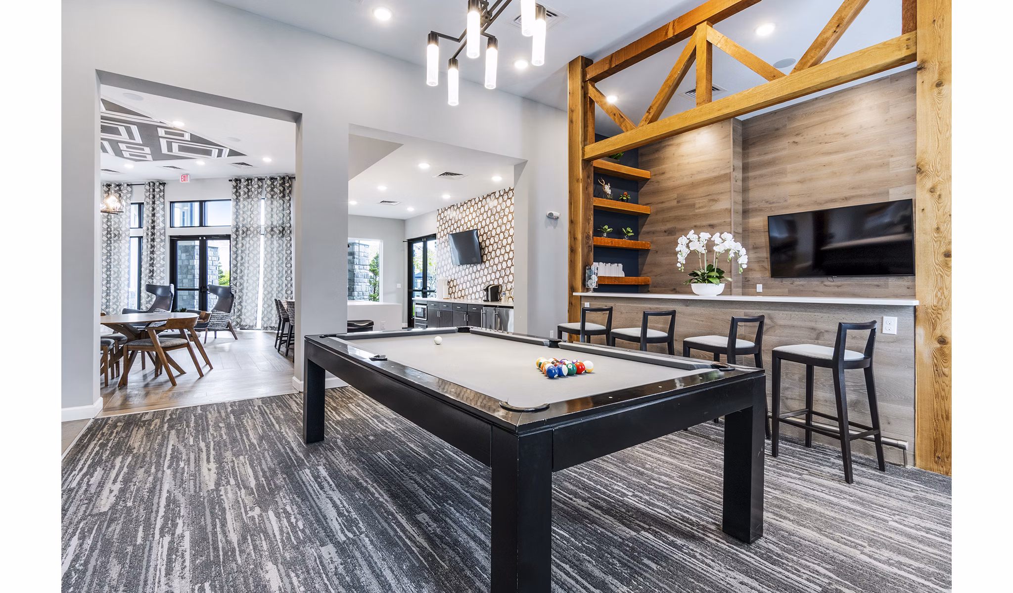 Modern game room with billiards table at The Landing at Tiffany Springs Apartments