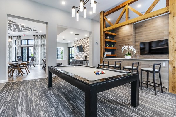 Modern game room with billiards table at The Landing at Tiffany Springs Apartments