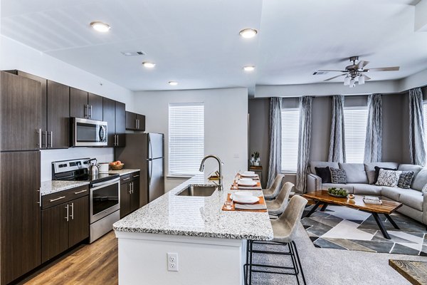 Modern kitchen with stainless steel appliances at The Landing at Tiffany Springs Apartments