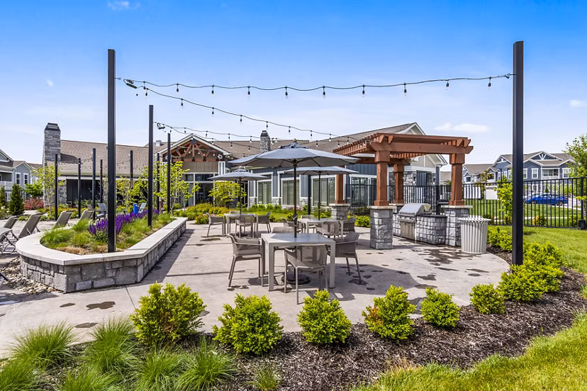 Outdoor dining space with modern grills at The Landing at Tiffany Springs Apartments