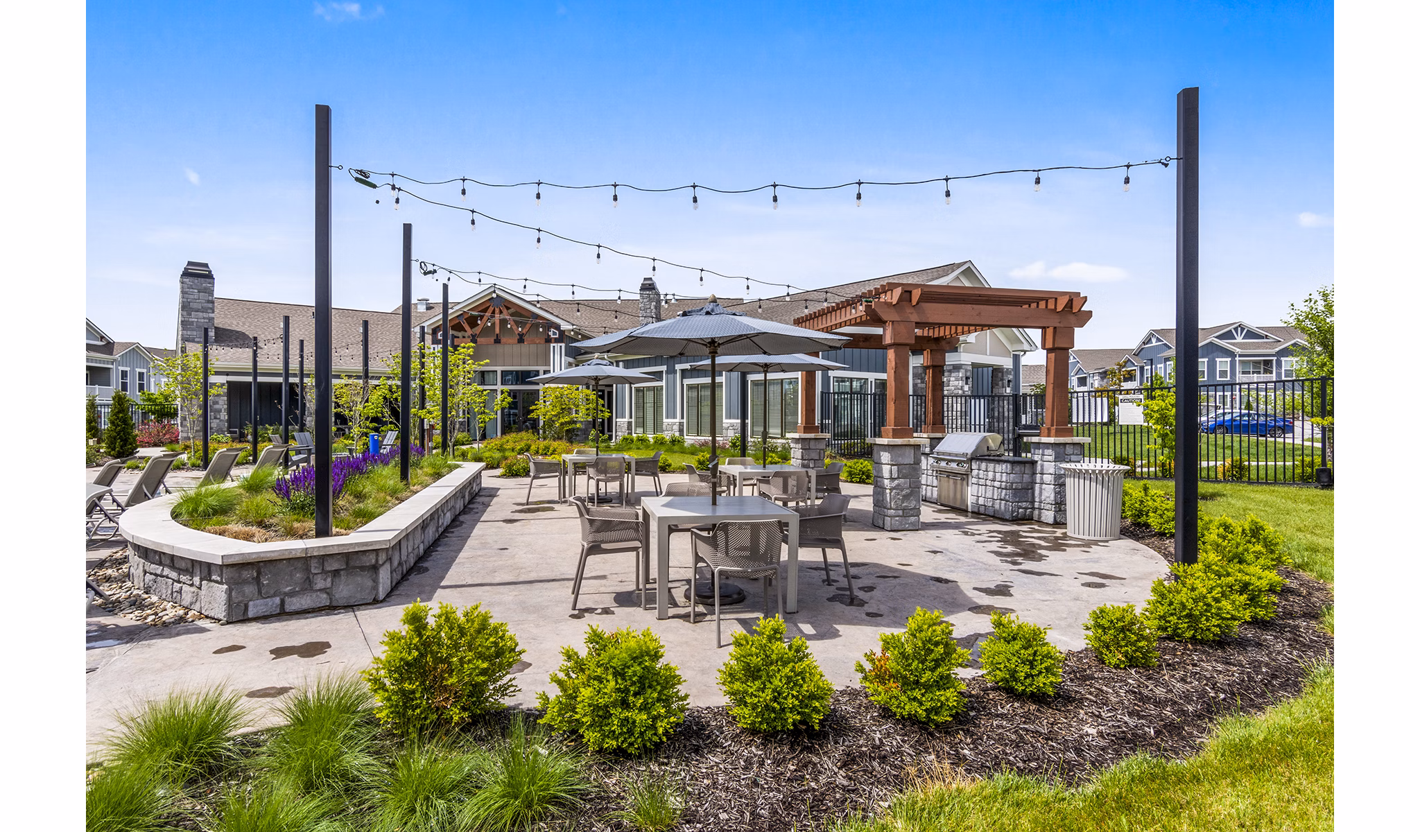Outdoor dining space with modern grills at The Landing at Tiffany Springs Apartments