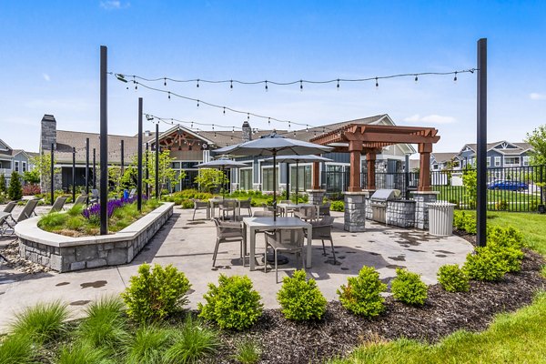 Outdoor dining space with modern grills at The Landing at Tiffany Springs Apartments