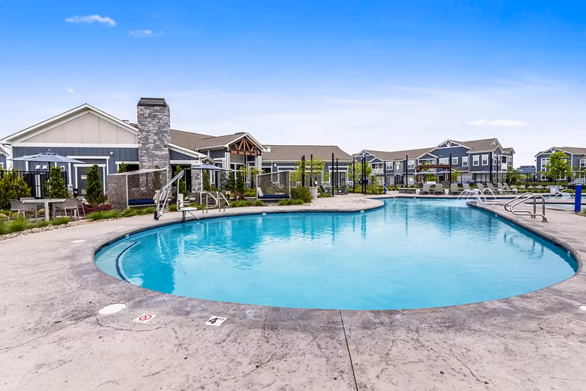 Luxurious pool with surrounding lounge chairs at The Landing at Tiffany Springs Apartments, offering a relaxing amenity in Kansas City