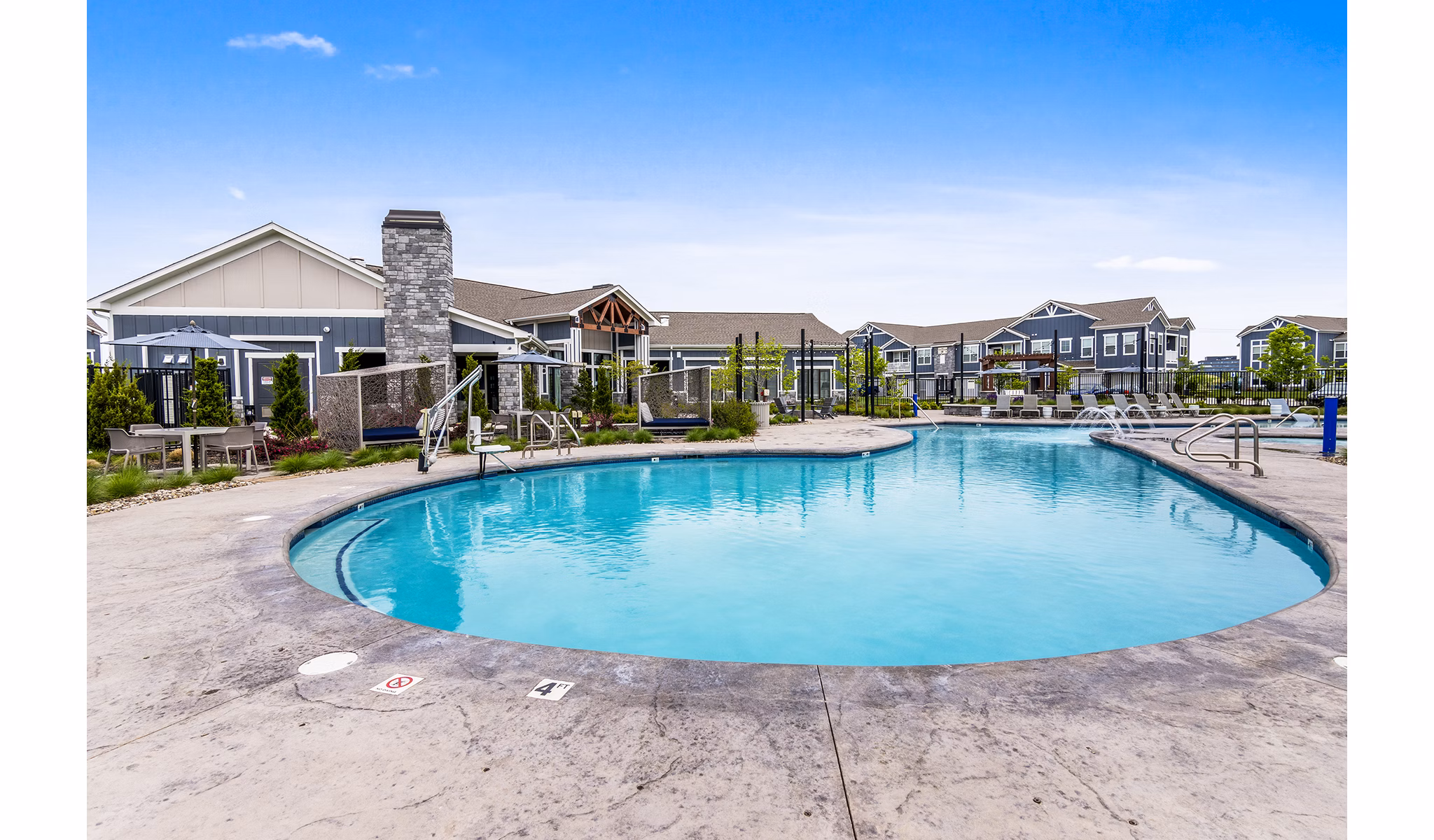 Luxurious pool with surrounding lounge chairs at The Landing at Tiffany Springs Apartments, offering a relaxing amenity in Kansas City