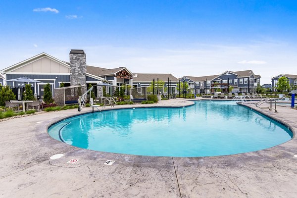 Luxurious pool with surrounding lounge chairs at The Landing at Tiffany Springs Apartments, offering a relaxing amenity in Kansas City