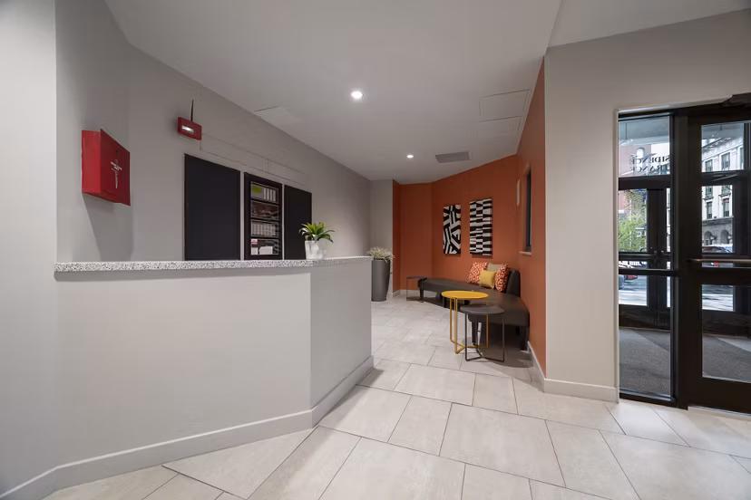 Modern clubhouse featuring sleek design and ample seating at The 6Hundred Apartments, ideal for social gatherings and relaxation