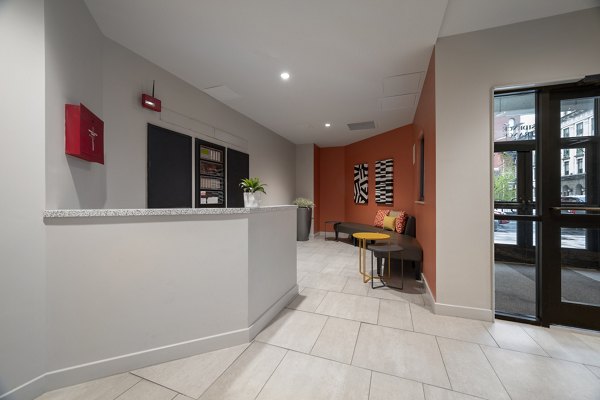 Modern clubhouse featuring sleek design and ample seating at The 6Hundred Apartments, ideal for social gatherings and relaxation