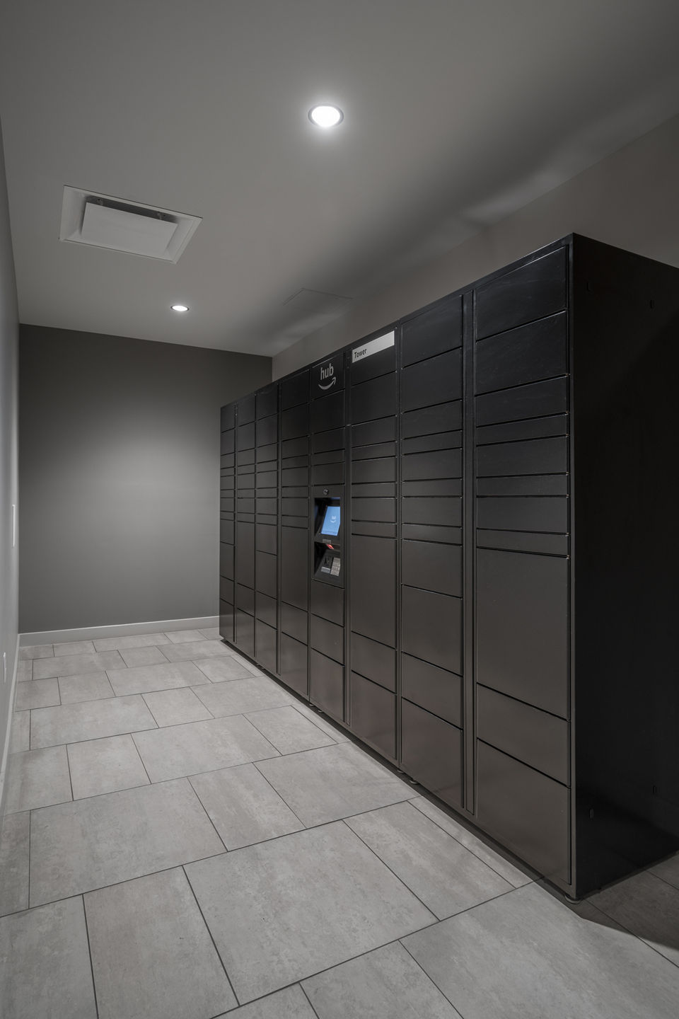 Modern mail room with secure package lockers at The 6Hundred Apartments