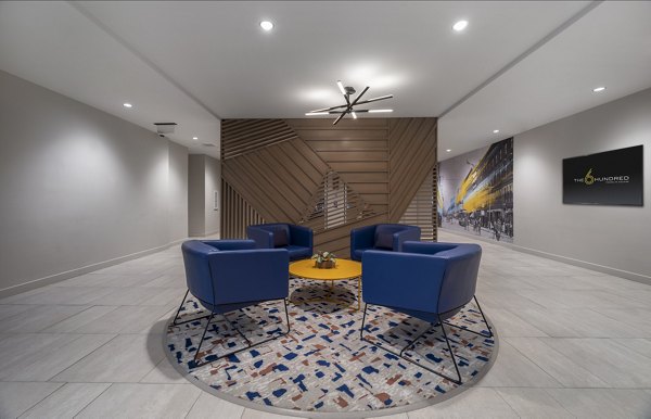 Modern clubhouse featuring cozy seating and entertainment area at The 6Hundred Apartments