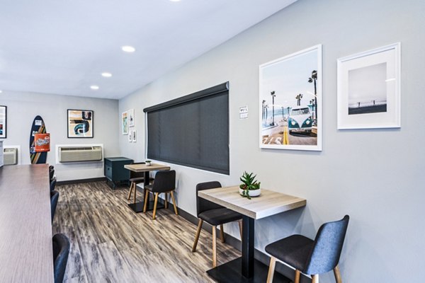 Clubhouse study area with modern furniture and ample lighting at Breakpointe Coronado Apartments