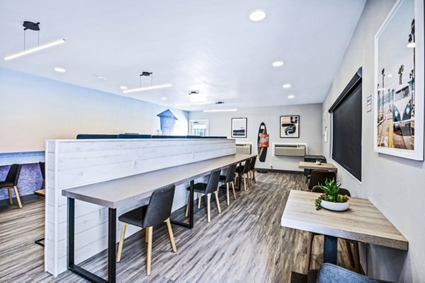 Clubhouse study area with communal tables and modern decor at Breakpointe Coronado Apartments
