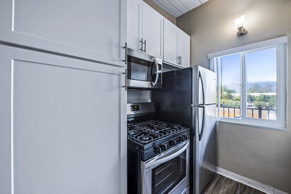 Kitchen featuring modern appliances and sleek cabinetry at Breakpointe Coronado Apartments
