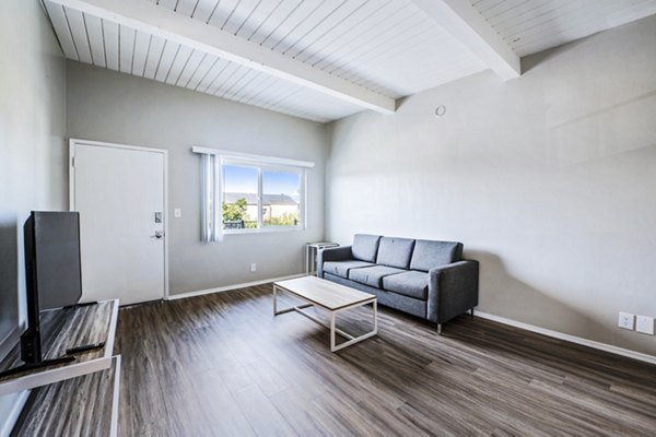 Spacious living room with contemporary furniture in Breakpointe Coronado Apartments luxury community